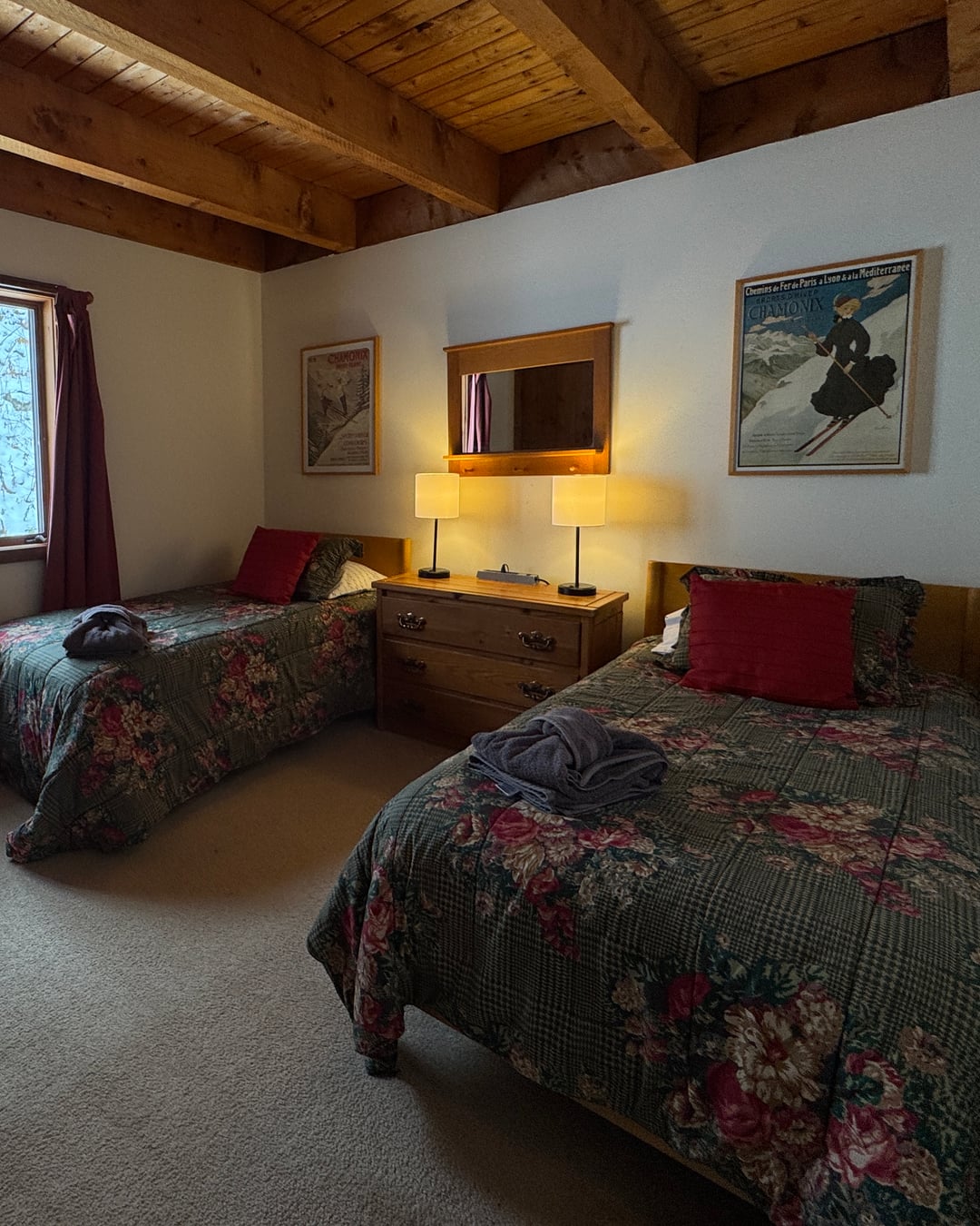 Bedroom 4: two twin beds under exposed beams.