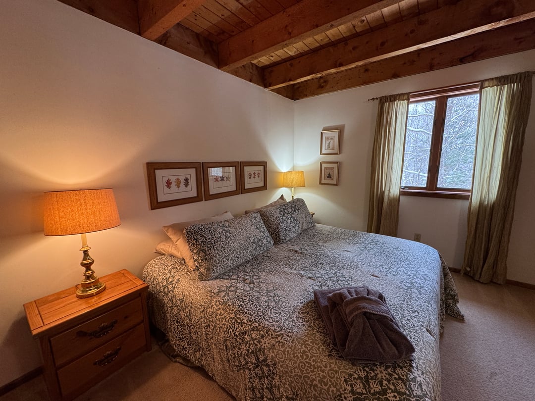 Bedroom 1: King bed close view, framed botanical prints