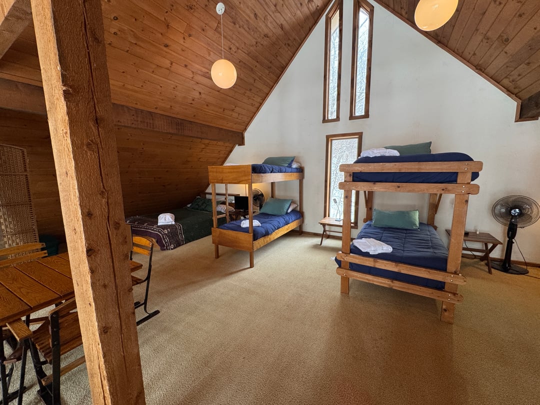 Loft: Gable end with narrow tall windows, two bunk sets, globe pendants